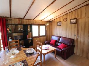 a living room with a couch and a table at Gîte Arpajon-sur-Cère, 3 pièces, 4 personnes - FR-1-742-21 in Arpajon-sur-Cère