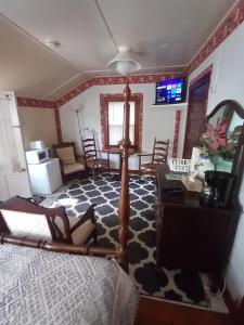 a bedroom with a bed and a table and chairs at Sea Breeze Inn beach rentals in Barnstable