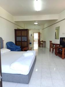 a hotel room with two beds and a living room at Lumut Valley Condominium in Lumut