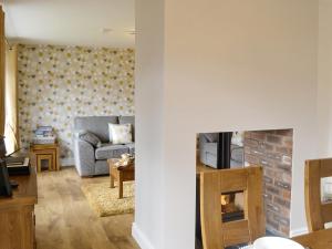 a living room with a couch and a fireplace at Rydal Cottage in Keswick