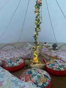 a room with four beds and a christmas tree at Country Bumpkins Luxury Glamping in Wellingore