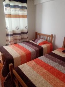 מיטה או מיטות בחדר ב-Hospedaje Vivanco