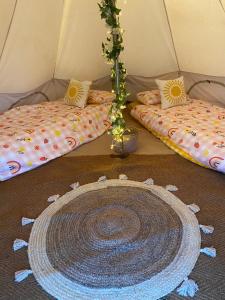 a room with two beds in a tent at Country Bumpkins Luxury Glamping in Wellingore