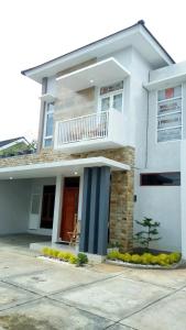 Casa blanca con balcón en la parte superior. en Walasa Ratri Indonesia Homes by MSH, en Purworejo