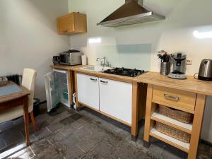 a kitchen with a sink and a stove top oven at Logies Oud Bergveen in Veenhuizen