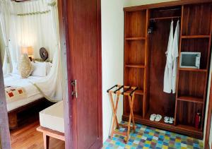 Pokój z sypialnią z łóżkiem i szafą w obiekcie Villa Nirvana w mieście Ubud