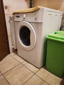 a washing machine in a room with a green trash can at Apartment Dragi - 250 m from beach in Supetar
