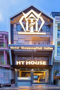 a hotel building with a sign that reads hotel shopping mall center at HT House in Da Lat
