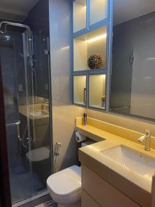 a bathroom with a shower and a toilet and a sink at E & T Homecation 2 Bedroom at SMDC Air Residences in Manila