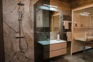 a bathroom with a shower and a sink at Blockhausen in Schwarzenberg am Bohmerwald