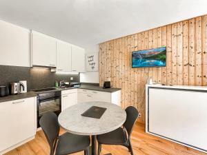 a kitchen with a table and chairs and a chalkboard at Pied de piste de Thyon - 4 Vallees in Vex