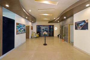 un pasillo de una oficina con un jarrón de flores en Sterling Karwar, en Kārwār