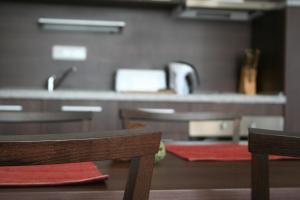 a kitchen with a counter and a table and two chairs at Apartments Helios in Pomorie