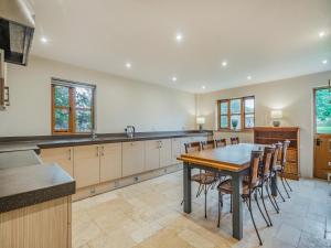 a large kitchen with a wooden table and chairs at Ringland Cottage in Attlebridge