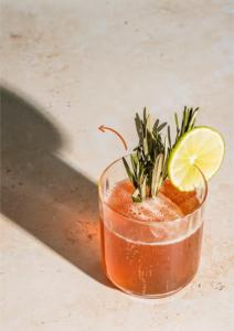 a drink in a glass with a plant in it at Riverdale Hotel in Kandy