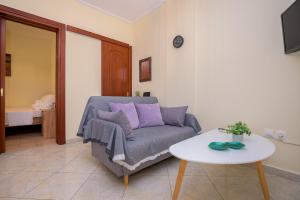 a living room with a couch and a table at ANNA'S APARTMENT in Alexandroupoli