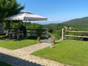 a patio with an umbrella and a picnic table at 916 Mountain Resort in Xanthi