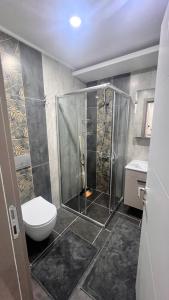 a bathroom with a shower and a toilet in it at SELİNTİ CİTY DAİRE 1 Suit in Gazipasa