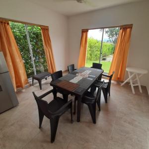 a dining room with a wooden table and chairs at Casa Campestre La Victoria piscina privada, wifi in Ricaurte