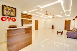 a large living room with a couch and a chair at Rvn Guest Inn in Nellore