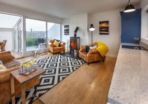 a living room with two couches and a fireplace at 20 Cae Du in Abersoch