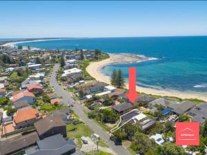an aerial view of a suburb with a red arrow pointing to a beach at Blissful Beachfront Pad - Pet Friendly - Direct Beach Access in Blue Bay 