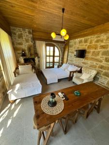 a living room with two beds and a table at KİNZİ İMROZ in Gokceada Town