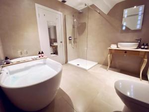 a bathroom with a tub and a sink and a shower at Olif in Betws-y-coed
