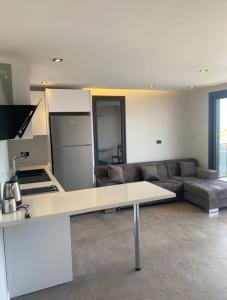 a kitchen and living room with a table and a couch at No 22 Çeşme in Çeşme