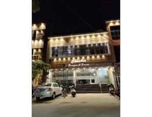 a building with a car parked in front of it at Chhabra Guest House, Kanpur in Kānpur