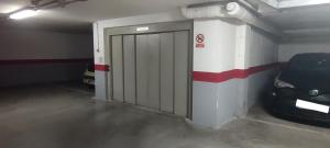 a garage with a car parked next to a garage door at Teruel 380 in Teruel