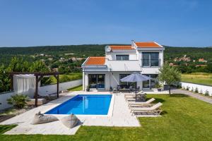 a villa with a swimming pool and a house at NEW Villa Anja is a 4 bedroom villa with a 32 sqm heated pool near Imotski in Imotski