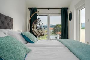 a bedroom with a bed with a swing and a window at NEW Villa Anja is a 4 bedroom villa with a 32 sqm heated pool near Imotski in Imotski +46 photos
