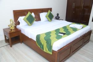 a bedroom with a large bed with a wooden frame at Divine India Service Apartment 3Bhk,B57 Sarita Vihar,Apollo in New Delhi