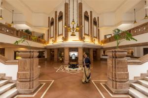 a woman stands in the lobby of a hotel at Trident Bhubaneswar in Bhubaneshwar