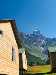 a house with a view of a mountain at Ushba Cottages in Mazeri