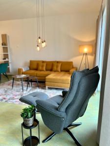a living room with a couch and a chair at Appartements Haus Augustinus in Münster