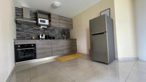 a kitchen with a large stainless steel refrigerator at Auae hills lodge in Faaa
