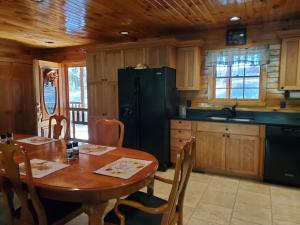 a kitchen with a table and a black refrigerator at Snyder's Knob in Millerstown