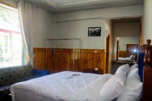 Kunhar Hotel RiverSide Block客房内的一张或多张床位