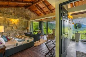 a bedroom with a bed in a room with a stone wall at StayVista at Leopard's Creek with Pool in Solan