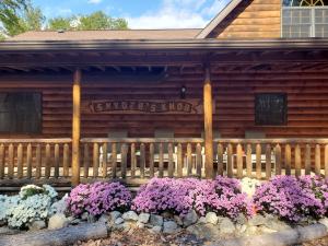 uma cerca de madeira com flores em frente a uma casa em Snyder's Knob em Millerstown