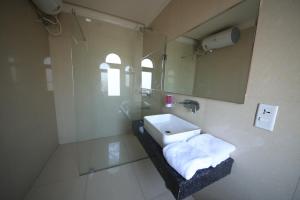 a bathroom with a sink and a mirror at Perfect Plus just 5 mins walk to Golden Temple in Amritsar +33 photos