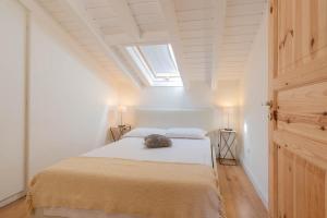 a bedroom with a bed and a skylight at The Leoncino Hotel in Brescia