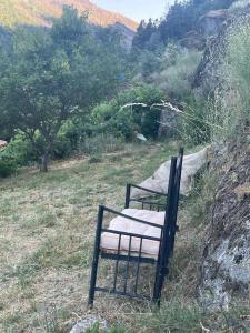 a bench sitting on a hill in a field at A Casa da Rapariga de Cabelo Azul in Manteigas
