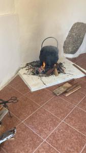 a pot on a fire in a room at A Casa da Rapariga de Cabelo Azul in Manteigas
