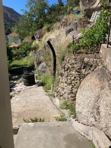 a stone path leading up to a building on a hill at A Casa da Rapariga de Cabelo Azul in Manteigas