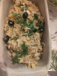 a casserole dish of food with rice and olives at A Casa da Rapariga de Cabelo Azul in Manteigas