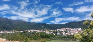 a view of a town in a valley with mountains at A Casa da Rapariga de Cabelo Azul in Manteigas