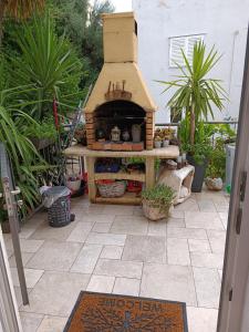 a garden with a pizza oven on a patio at Zelena oaza in Baška Voda